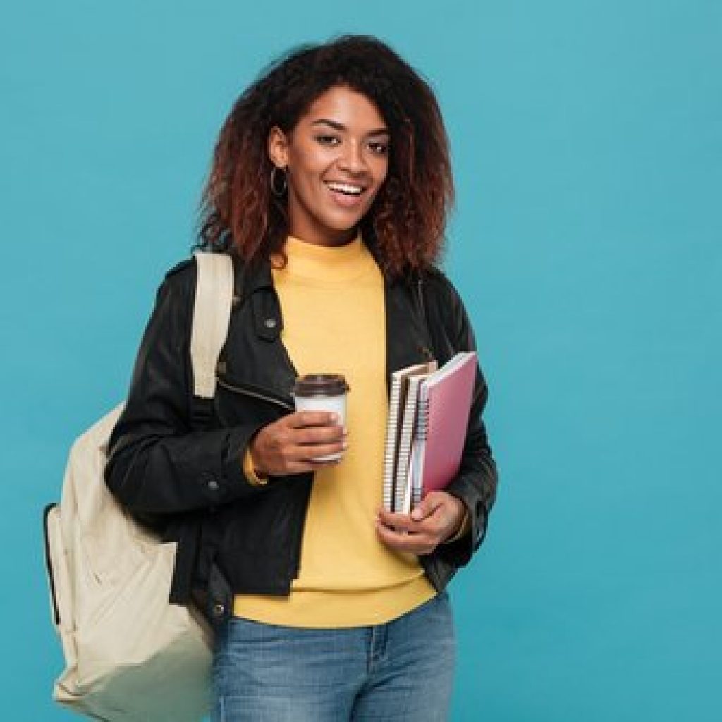 happy-young-african-woman-holding-notebooks-coffee (1)